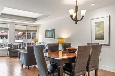 a dining room with a table and chairs at Mountain View 2BR Condo with Hot Tub, Pool and Gym in Canmore
