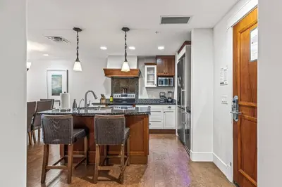 a kitchen with a sink and a counter top at Mountain View 2BR Condo with Hot Tub, Pool and Gym in Canmore