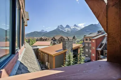 a view from a balcony with mountains in the background at Spacious Rockies Escape near Banff Hot tub and Gym in Canmore