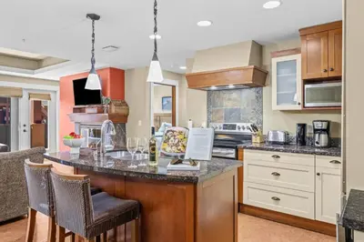 a kitchen with a large island with bar stools at Spacious Rockies Escape near Banff Hot tub and Gym in Canmore