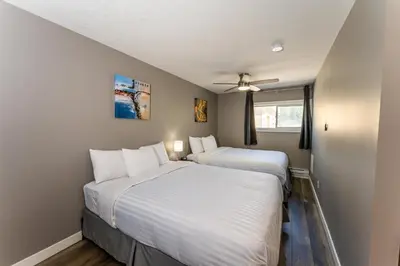 two beds in a small room with a window at Hinton Highway Inn in Hinton