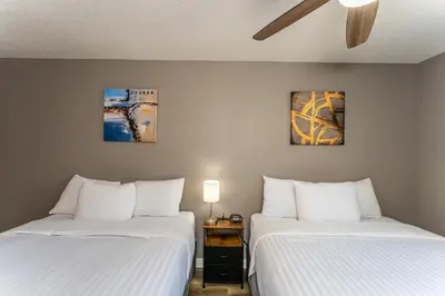 two beds sitting next to each other in a room at Hinton Highway Inn in Hinton