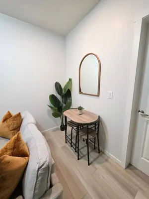a living room with a table and a couch at Amaville - Two BRM Suite in West Edmonton in Edmonton
