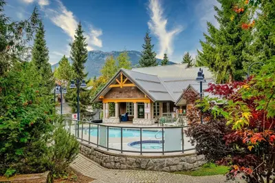 a home with a swimming pool and a house at Private Hot Tub | Pool | Free Parking | Sauna in Whistler