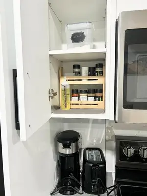 a kitchen cabinet with a coffee maker and a microwave at Cozy 2 Bedroom Suite Close to Amenities in Edmonton