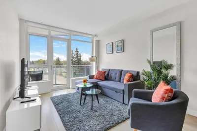 a living room with a couch and a tv at Parkside at Waterfront in Downtown Calgary in Calgary