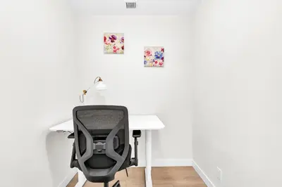 a desk with a chair and a desk with a lamp at Parkside at Waterfront in Downtown Calgary in Calgary
