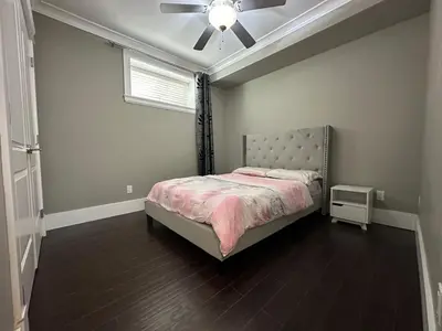 a bedroom with a bed and a ceiling fan at Bright & Cozy 1B1B in Vancouver-close to YVR Airport & DT, Free Parking, Private Entrance, in Vancouver
