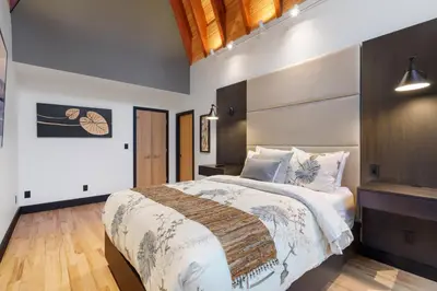 a bedroom with a large bed in a room at Luxury Whistler 6BR Chalet, Hot Tub and Music Loft in Whistler