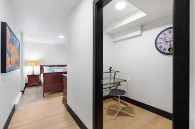 a mirror in a room with a clock on the wall at Luxury Whistler 6BR Chalet, Hot Tub and Music Loft in Whistler