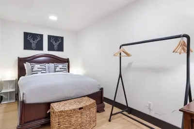 a bedroom with a bed and a lamp at Luxury Whistler 6BR Chalet, Hot Tub and Music Loft in Whistler