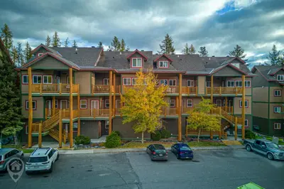a large apartment building with cars parked in a parking lot at Kimberley Ridge by StayIn in Kimberley