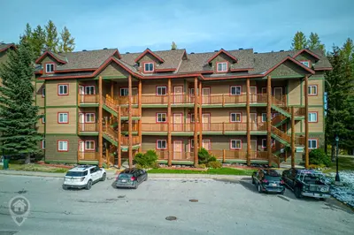 a large apartment building with cars parked in a parking lot at Kimberley Ridge by StayIn in Kimberley