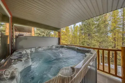 a hot tub on the balcony of a house at Kimberley Ridge by StayIn in Kimberley