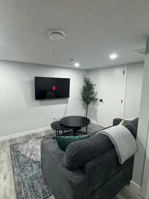a living room with a couch and a table at Modern comfort just 20 minutes from the airport, with a full kitchen in Edmonton