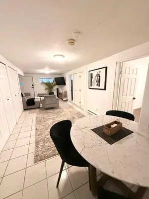 a living room with a marble table and chairs at Newly Renovated - Self contained Suite - Sleeps 6 in Vancouver