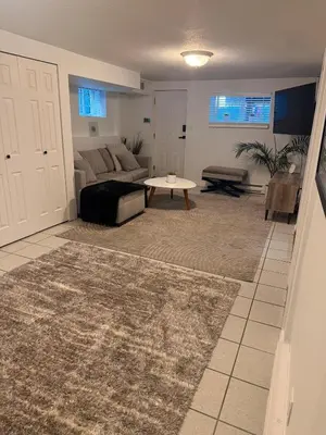 a living room with a couch and a table at Newly Renovated - Self contained Suite - Sleeps 6 in Vancouver