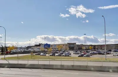 a parking lot with cars parked in a parking lot at The Spruce Modern 2BR Condo with Pool & Parking in Calgary