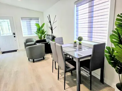 a dining room with a table and chairs at The Oasis in Stettler in Stettler