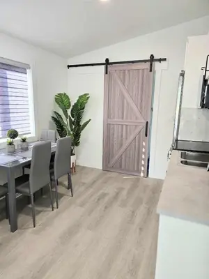 a dining room with a table and a barn door at The Oasis in Stettler in Stettler
