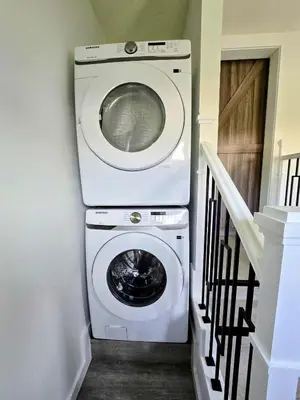 a washer and dryer in a room with a staircase at The Oasis in Stettler in Stettler