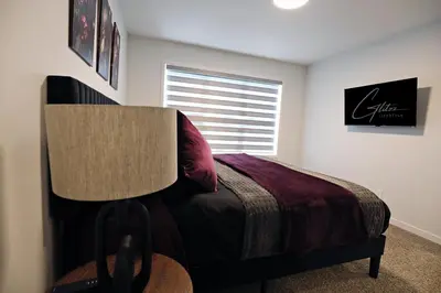 a bedroom with a bed and a window at Seton 4BR Family Home 5 Min to South Campus in Calgary