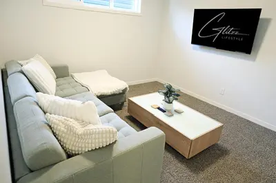 a living room with a couch and a coffee table at Seton 4BR Family Home 5 Min to South Campus in Calgary