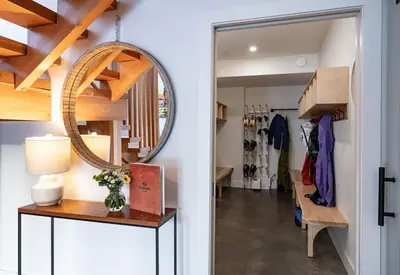 a hallway with a mirror and a dressing room at CAPOW House in Revelstoke