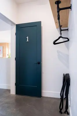 a blue door in a room with a camera at CAPOW House in Revelstoke