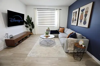 a living room with a couch and a table at Kinglet 4BR Getaway AC Garage Near WEM DisneyPlus in Edmonton