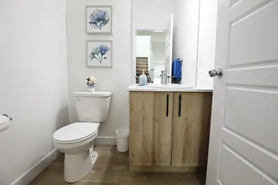 a bathroom with a toilet and a sink at Kinglet 4BR Getaway AC Garage Near WEM DisneyPlus in Edmonton