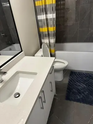 a bathroom with a sink and a toilet and a shower at Bedroom in the basement Upland 1 in Edmonton