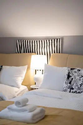 a bed with two towels sitting on top of it at Brand New Stylish 2 bedrooms Suite in Shaughnessy in Vancouver