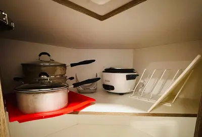 two pots and pans on a shelf in a kitchen at Casa Del Mar-A family Suite in Victoria in Langford