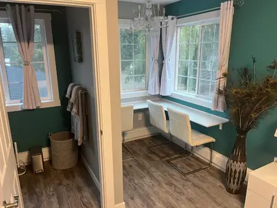 a home office with a desk and windows at Ellison Funny Farm in Barrière