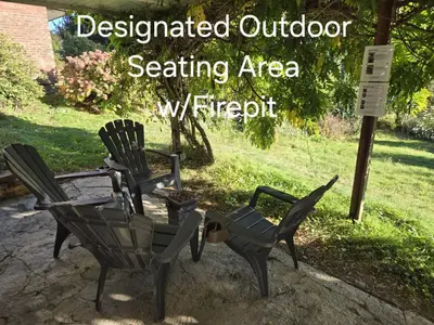 a group of chairs sitting next to a sign at Self Check-In Keyless Private Entry DBL Queen Suite in Mission City