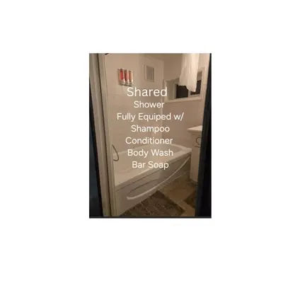 a mirror in a bathroom with a sign on the door at Self Check-In Keyless Private Entry DBL Queen Suite in Mission City