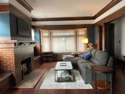 a living room with a couch and a fireplace at The Algonquin Residence in Prince Rupert