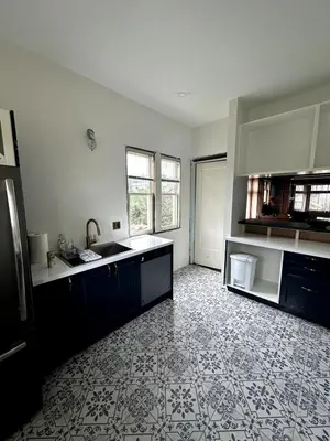 an empty kitchen with a sink and a counter at The Algonquin Residence in Prince Rupert