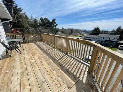 a wooden deck with a picnic table on it at 3 BR Serene Forest Sanctuary in Port Edward