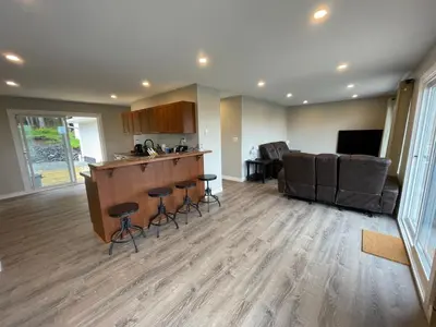 a kitchen and living room with a bar and a couch at 3 BR Serene Forest Sanctuary in Port Edward