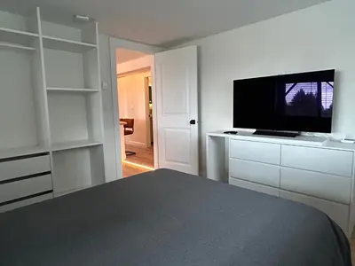 a bedroom with a flat screen tv and a bed at 2BR Seaside Haven Retreat