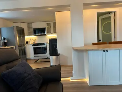 a kitchen and living room with a counter in a room at 2BR Seaside Haven Retreat