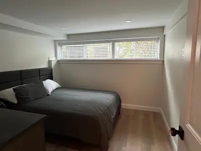 a bedroom with a bed and a window at 2BR Seaside Haven Retreat