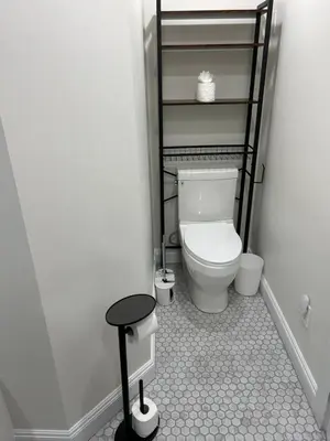 a small bathroom with a toilet and a stool at 2BR Seaside Haven Retreat