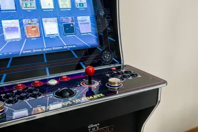 a pinball machine with a screen on top of it at 3BR Rockies Condo Heated Pool and Hot Tub in Canmore