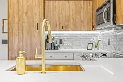 a kitchen with a sink and a faucet at Spacious 2BR Minutes from Downtown w Pool and Hot Tub in Canmore