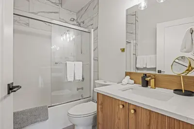 a bathroom with a sink and a toilet and a shower at Spacious 2BR Minutes from Downtown w Pool and Hot Tub in Canmore