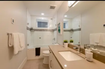 a bathroom with a sink and a toilet and a tub at 2BR Suite Close to Transit - Great for FIFA Vancouver in Burnaby