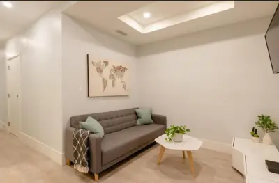 a living room with a couch and a table at 2BR Suite Close to Transit - Great for FIFA Vancouver in Burnaby
